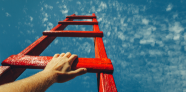 A hand reaching up on a ladder, symbolizing the upward growth trajectory of associations